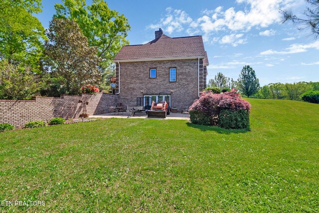 300 Lowe Rd, Huntsville, TN 37756 - back of property with a lawn, brick siding, a chimney, and a patio area