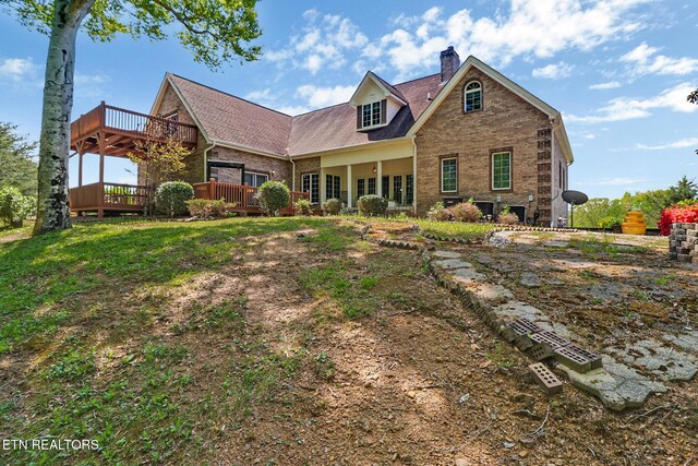 300 Lowe Rd, Huntsville, TN 37756 - view of front of home featuring brick siding, a wooden deck, and a chimney