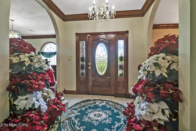300 Lowe Rd, Huntsville, TN 37756 - tiled entrance foyer featuring an inviting chandelier, arched walkways, and crown molding