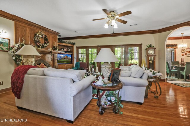 300 Lowe Rd, Huntsville, TN 37756 - living room with ornamental molding, ceiling fan with notable chandelier, wood finished floors, and visible vents