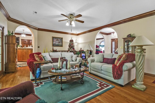 300 Lowe Rd, Huntsville, TN 37756 - living room featuring a ceiling fan, visible vents, arched walkways, wood finished floors, and ornamental molding