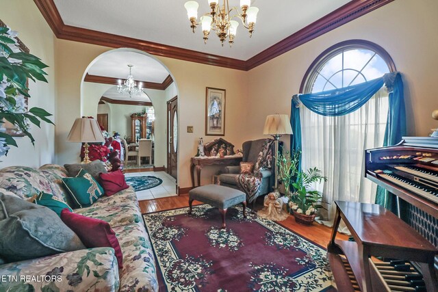 300 Lowe Rd, Huntsville, TN 37756 - sitting room with crown molding, arched walkways, wood finished floors, and a notable chandelier