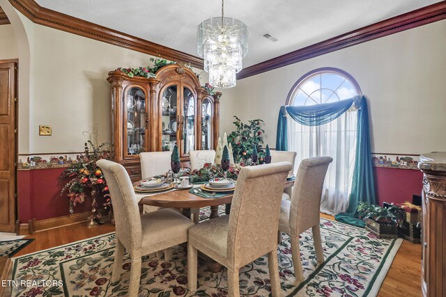 300 Lowe Rd, Huntsville, TN 37756 - dining area with ornamental molding, arched walkways, wood finished floors, and a chandelier