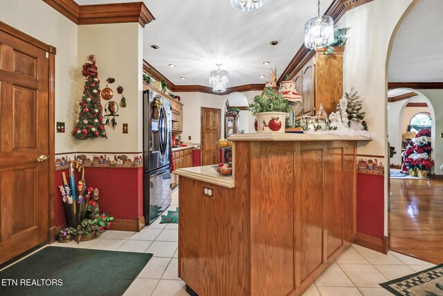 300 Lowe Rd, Huntsville, TN 37756 - kitchen with light countertops, arched walkways, light tile patterned floors, and refrigerator with ice dispenser