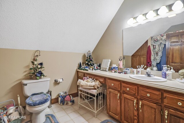 300 Lowe Rd, Huntsville, TN 37756 - bathroom with toilet, vaulted ceiling, tile patterned flooring, and vanity