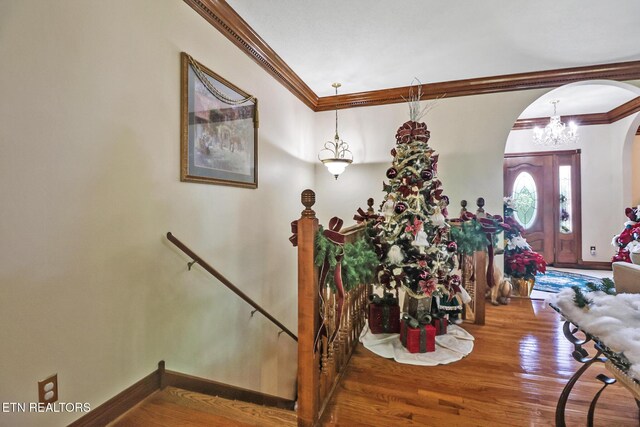 300 Lowe Rd, Huntsville, TN 37756 - foyer with crown molding, arched walkways, wood finished floors, baseboards, and a notable chandelier