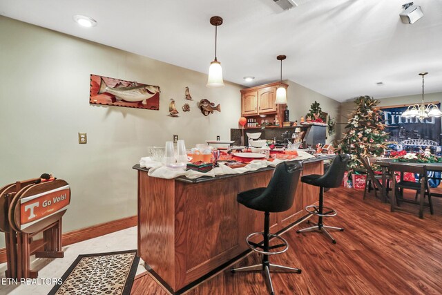 300 Lowe Rd, Huntsville, TN 37756 - bar with baseboards, a dry bar, wood finished floors, and hanging light fixtures