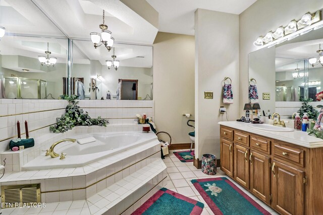300 Lowe Rd, Huntsville, TN 37756 - bathroom with tile patterned flooring, vanity, baseboards, a bath, and a chandelier