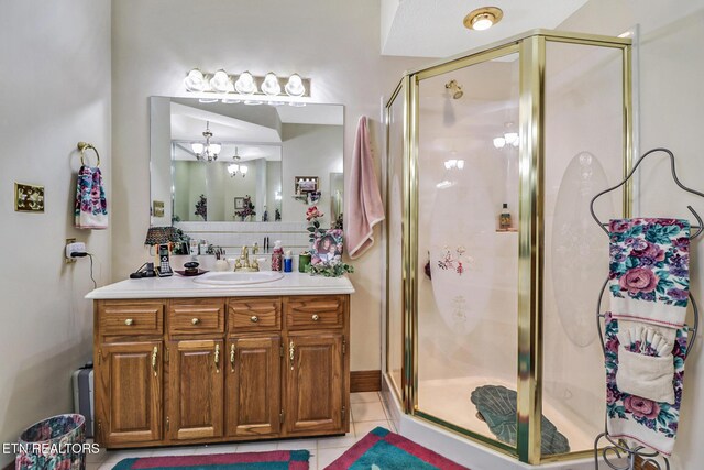 300 Lowe Rd, Huntsville, TN 37756 - full bathroom featuring vanity, an inviting chandelier, tile patterned floors, a shower stall, and tasteful backsplash