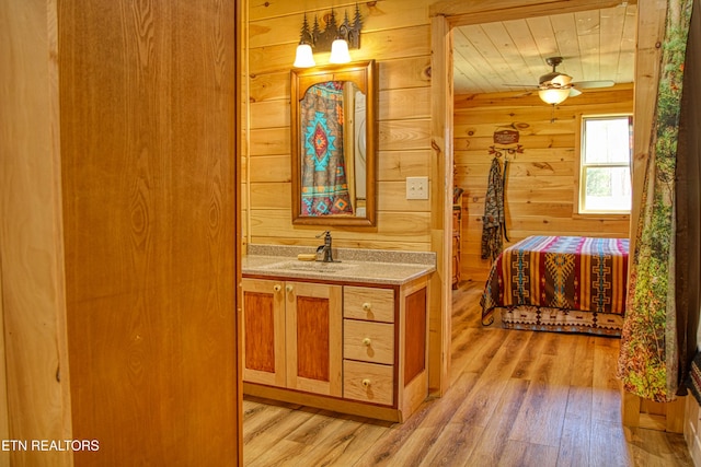 2025 Allardt Tinch Rd, Jamestown, TN 38556 - bathroom with wood finished floors, wood walls, vanity, and ceiling fan