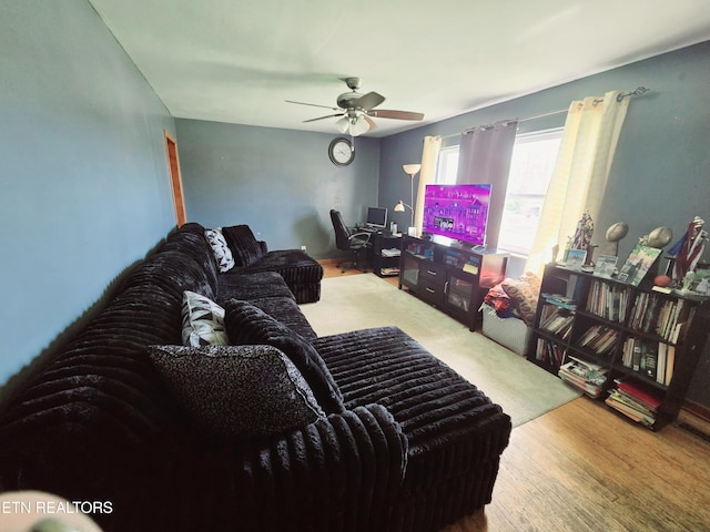 living area featuring wood finished floors and a ceiling fan