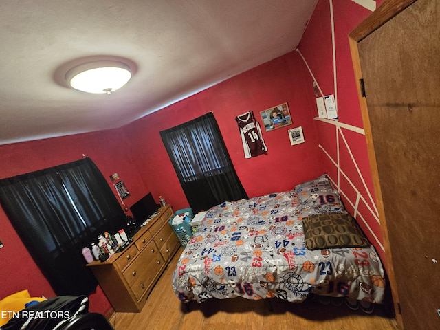 bedroom with wood finished floors