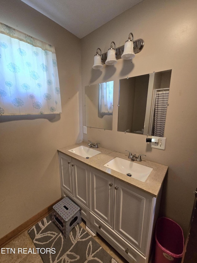 bathroom with a sink and double vanity