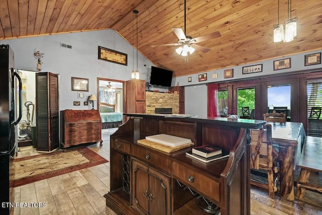 interior space with light wood-style floors, wooden ceiling, and a ceiling fan