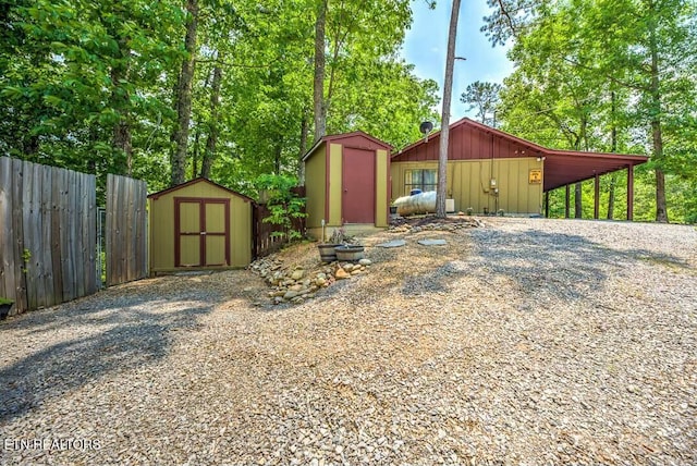 view of shed featuring fence
