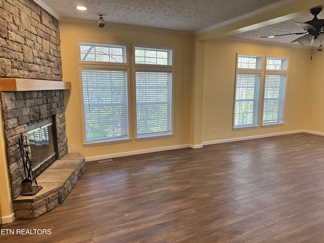 337 Costner Rd, Cosby, TN 37722 - unfurnished living room featuring crown molding, dark wood-style flooring, ceiling fan, and a stone fireplace