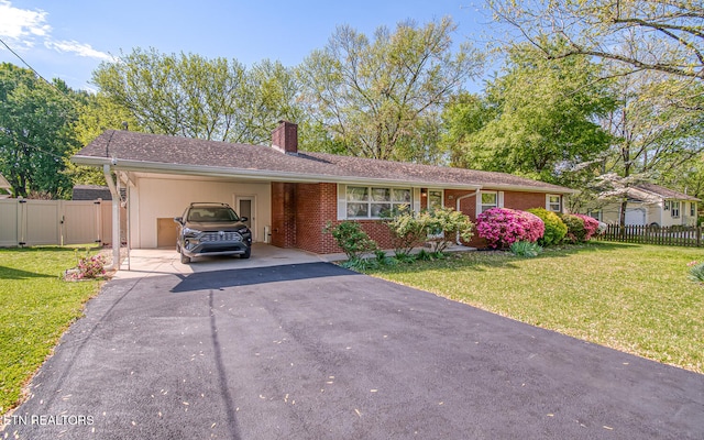 ranch-style home with a gate, aphalt driveway, fence, a front yard, and brick siding