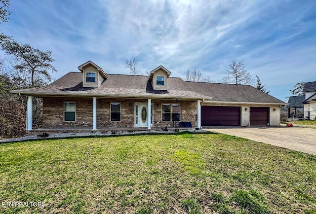 cape cod house with a garage, brick siding, driveway, and a front lawn