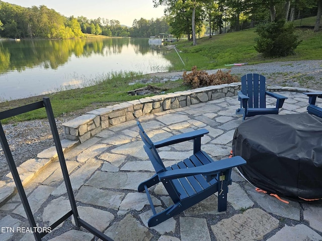 view of patio / terrace featuring a water view and a grill