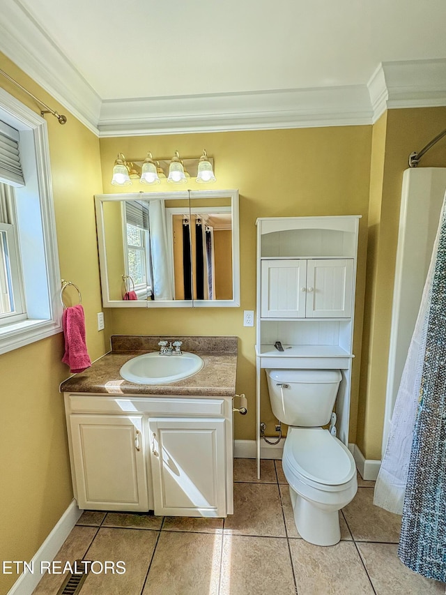 bathroom with crown molding, tile patterned floors, vanity, baseboards, and toilet