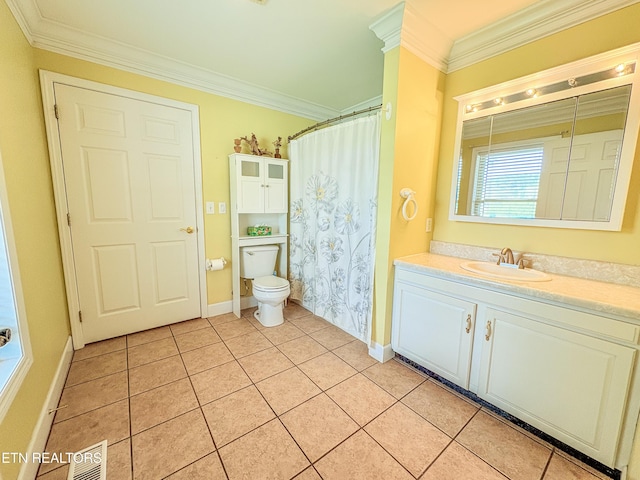 bathroom featuring tile patterned floors, toilet, vanity, ornamental molding, and baseboards