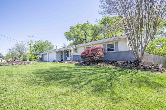 ranch-style home featuring a garage, fence, a front lawn, and brick siding