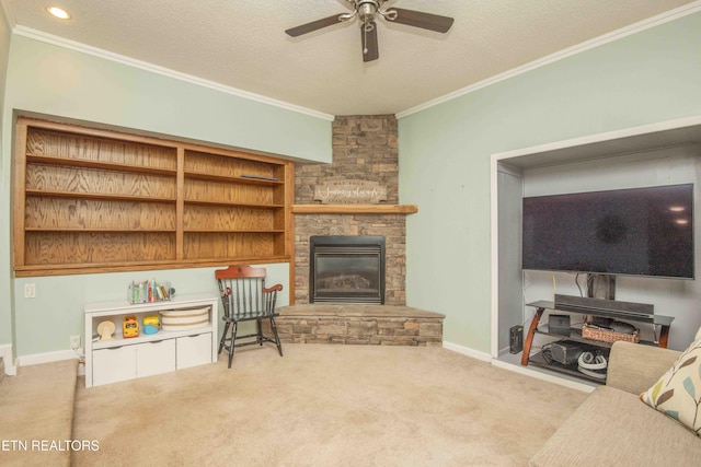 living room featuring crown molding, a ceiling fan, a stone fireplace, and carpet floors