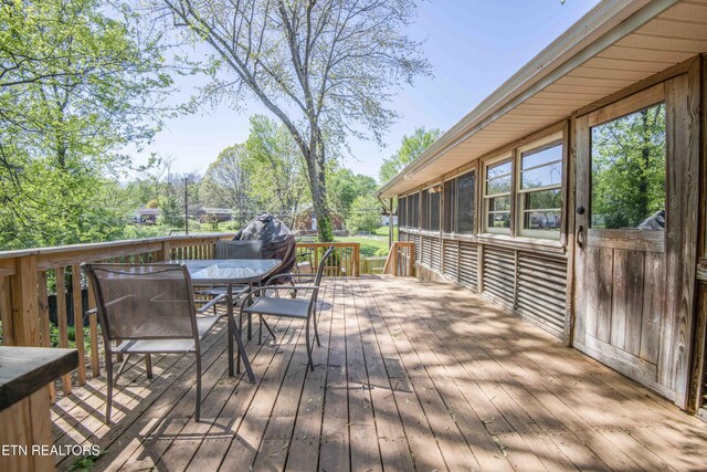 wooden deck with outdoor dining area