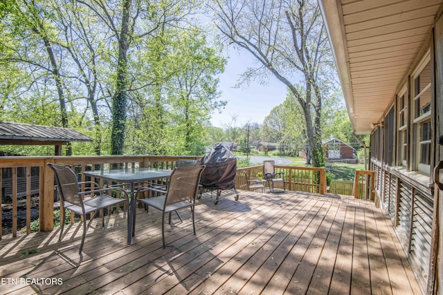 wooden terrace featuring outdoor dining area