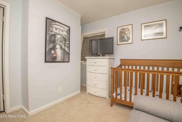 bedroom with light colored carpet and baseboards