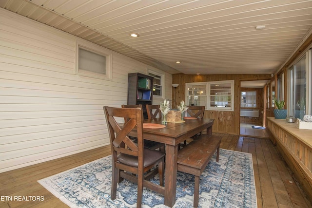 dining area featuring wooden walls, recessed lighting, hardwood / wood-style floors, and wood ceiling