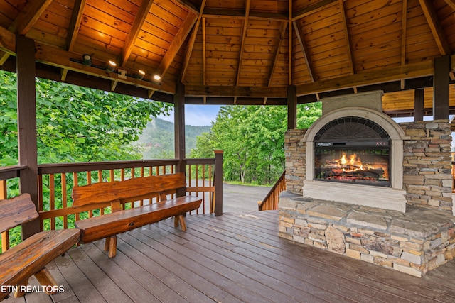 3219 Grouse Ridge Ln, Sevierville, TN 37862 - deck with an outdoor stone fireplace, a gazebo, and a mountain view