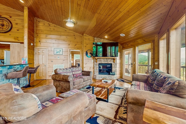 3219 Grouse Ridge Ln, Sevierville, TN 37862 - living room with vaulted ceiling, wooden ceiling, wood finished floors, wooden walls, and a stone fireplace
