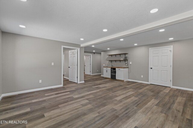 613 N St, Newport, TN 37821 - unfurnished living room with indoor bar, wood finished floors, and baseboards