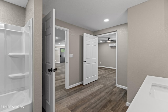 613 N St, Newport, TN 37821 - full bathroom with recessed lighting, wood finished floors, a textured wall, an AC wall unit, and a sink