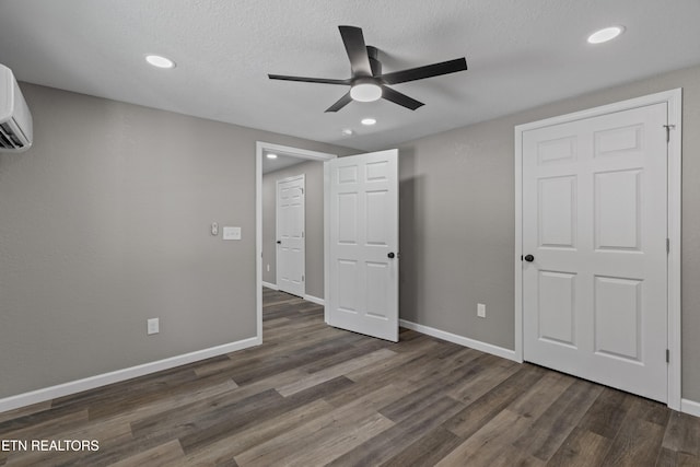 613 N St, Newport, TN 37821 - unfurnished bedroom featuring a wall mounted air conditioner, baseboards, wood finished floors, and recessed lighting