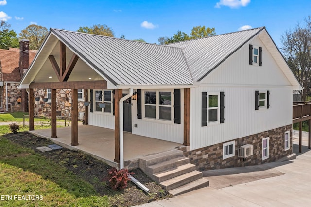 613 N St, Newport, TN 37821 - back of property featuring a patio area, a wall unit AC, a standing seam roof, and metal roof