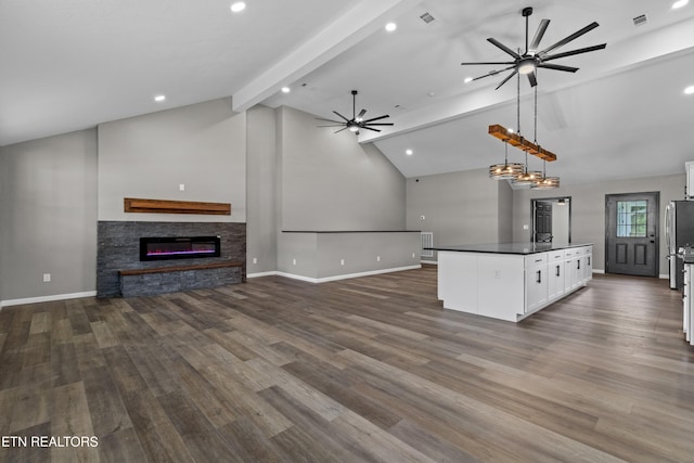 613 N St, Newport, TN 37821 - kitchen with dark countertops, lofted ceiling with beams, open floor plan, ceiling fan, and white cabinetry
