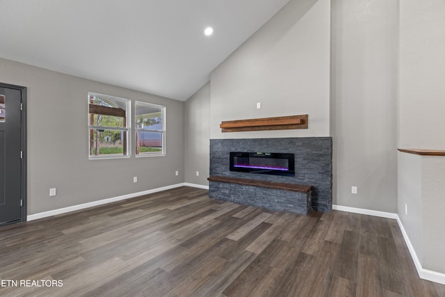 613 N St, Newport, TN 37821 - unfurnished living room with baseboards, wood finished floors, a glass covered fireplace, and high vaulted ceiling