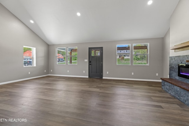 613 N St, Newport, TN 37821 - unfurnished living room with recessed lighting, lofted ceiling, a stone fireplace, and plenty of natural light