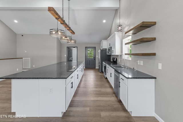 613 N St, Newport, TN 37821 - kitchen featuring stainless steel appliances, a sink, a large island, visible vents, and open shelves