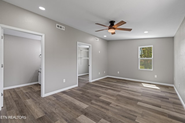 613 N St, Newport, TN 37821 - unfurnished bedroom featuring wood finished floors, a spacious closet, baseboards, visible vents, and recessed lighting