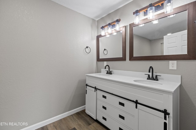 613 N St, Newport, TN 37821 - full bathroom with baseboards, wood finished floors, a sink, and double vanity