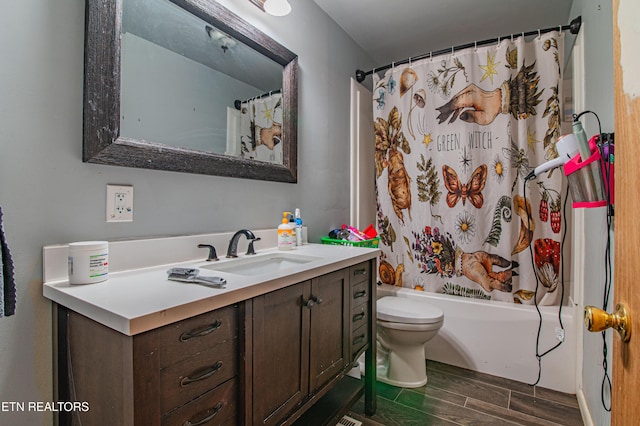 full bathroom with toilet, vanity, wood finished floors, and shower / bath combination with curtain