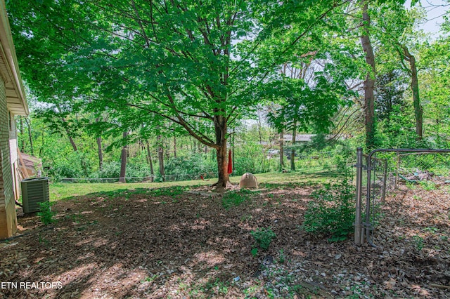 view of yard featuring fence and cooling unit