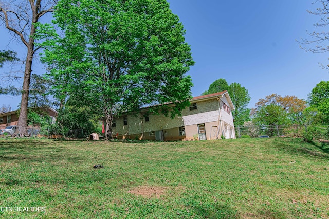 view of yard featuring fence and a garage