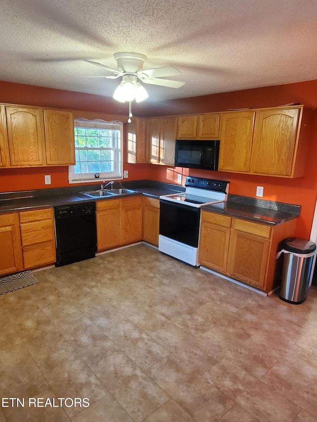 kitchen featuring a textured ceiling, dark countertops, black appliances, ceiling fan, and a sink