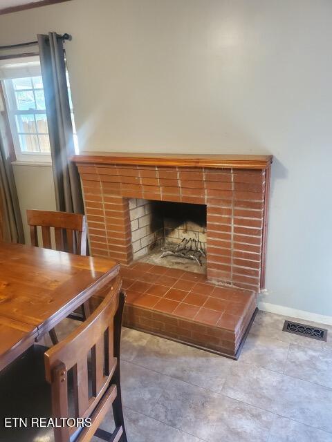 room details with baseboards, a fireplace, and visible vents
