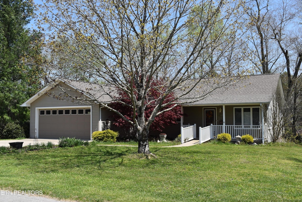 332 Yonside Dr, Sparta, TN 38583 - ranch-style home featuring roof with shingles, driveway, a front yard, a porch, and a garage