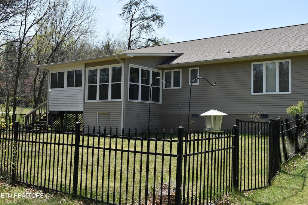 332 Yonside Dr, Sparta, TN 38583 - back of house featuring a yard, a sunroom, fence private yard, and stairs